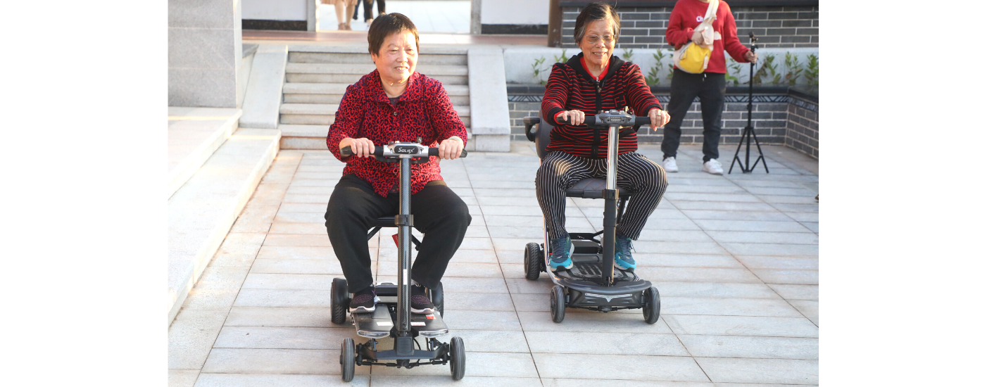 Two Seniors riding Solax mobility scooters